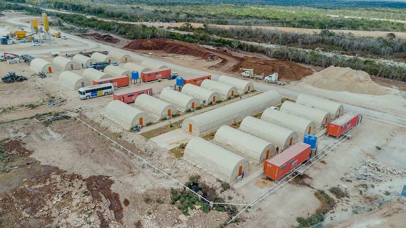 Construction site camp with tents and heavy equipment